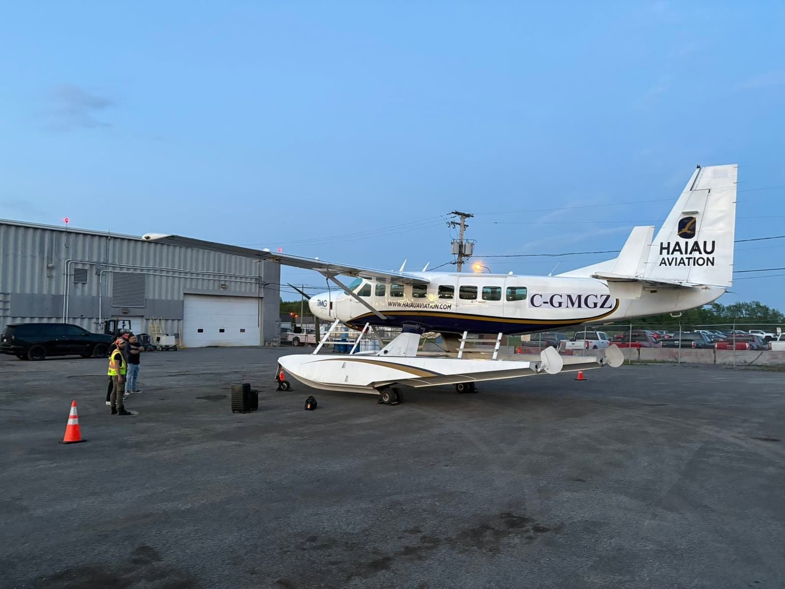 The amphibious Cessna 208 Caravan, registration C-GMGZ, on a ramp at dusk, still in its former operator's Hai Au Aviation livery.