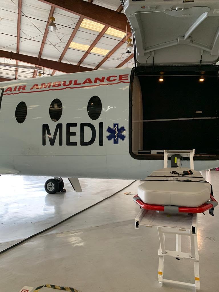 A stretcher on the loader beside AIR AMBULANCE and MEDI titles.