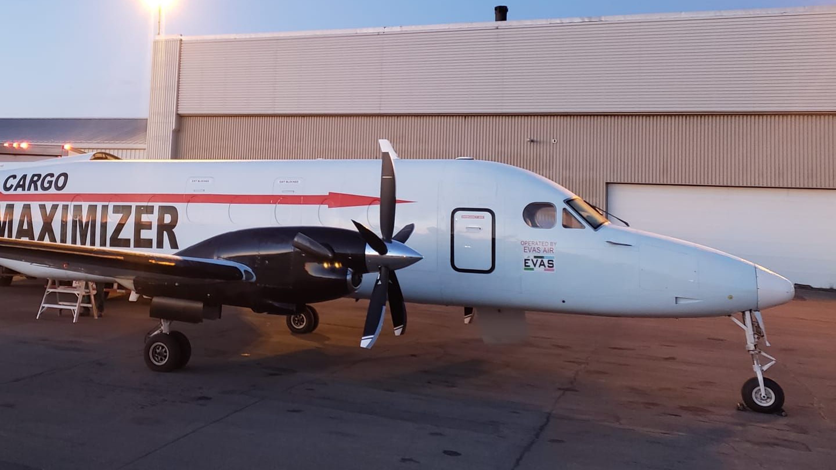 The forward fuselage, propeller and nose of a Beechcraft 1900D freighter at dusk