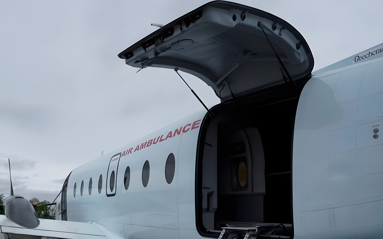 A stretcher on the loading ramp at the open rear door of a Beechcraft 1900D air ambulance